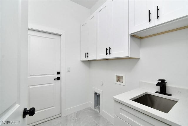 laundry area featuring marble finish floor, hookup for a washing machine, cabinet space, a sink, and electric dryer hookup