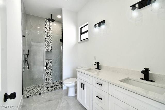 full bath with marble finish floor, a sink, a shower stall, and toilet