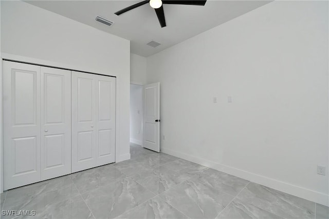 unfurnished bedroom with ceiling fan, a closet, visible vents, and baseboards