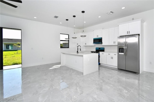 kitchen with an island with sink, visible vents, appliances with stainless steel finishes, and a sink