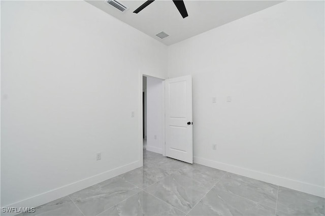 empty room with a ceiling fan, visible vents, and baseboards