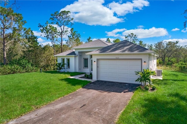 ranch-style house featuring a front yard, central AC, and a garage