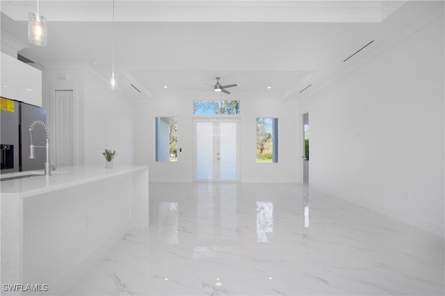 interior space featuring ceiling fan, french doors, crown molding, and sink