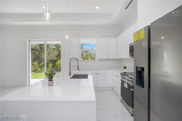 kitchen featuring light stone countertops, white cabinetry, sink, stainless steel appliances, and pendant lighting