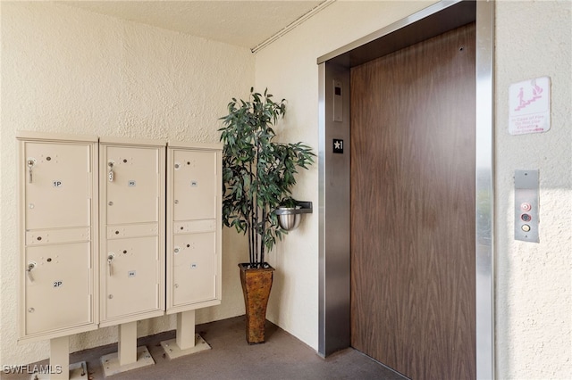 interior space featuring elevator and a mail area