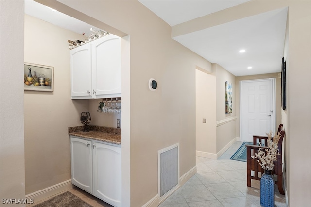 corridor featuring light tile patterned flooring