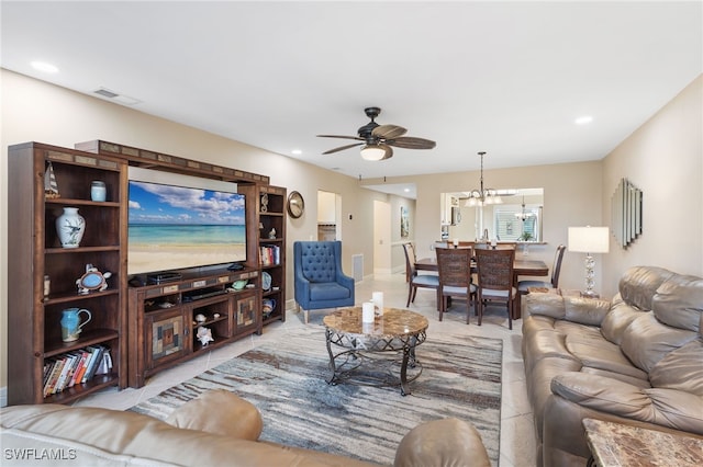 living room with ceiling fan with notable chandelier