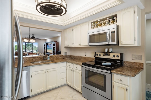 kitchen with light tile patterned flooring, stainless steel appliances, white cabinetry, and sink