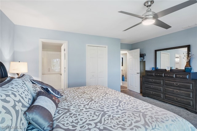 carpeted bedroom featuring ensuite bath, ceiling fan, and a closet