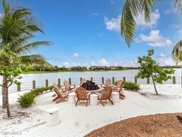 view of patio / terrace with a water view and a fire pit