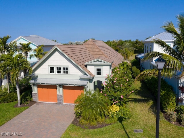 view of front of house with a garage and a front yard