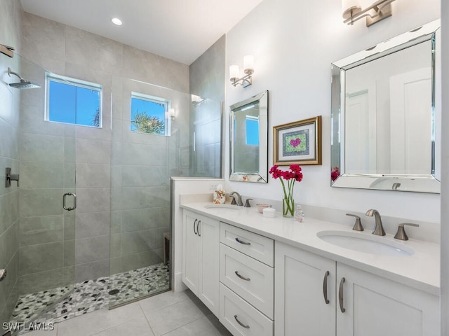 bathroom featuring vanity, tile patterned flooring, and a shower with door