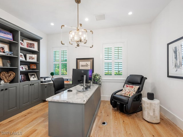 office featuring a notable chandelier and light hardwood / wood-style flooring