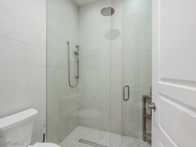 bathroom with toilet and walk in shower