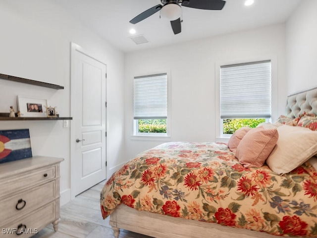 bedroom with ceiling fan and light wood-type flooring