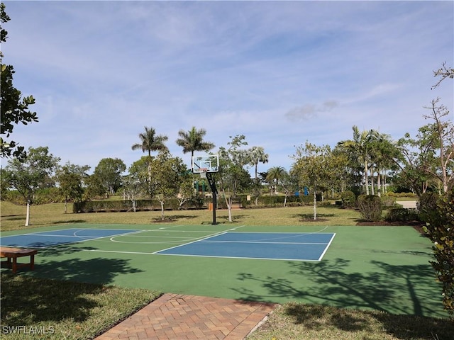 view of basketball court with a yard