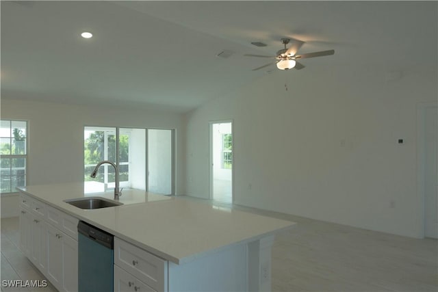 kitchen with a wealth of natural light, sink, stainless steel dishwasher, a kitchen island with sink, and white cabinets