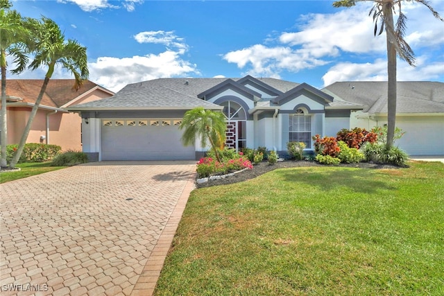 ranch-style home featuring a front lawn and a garage