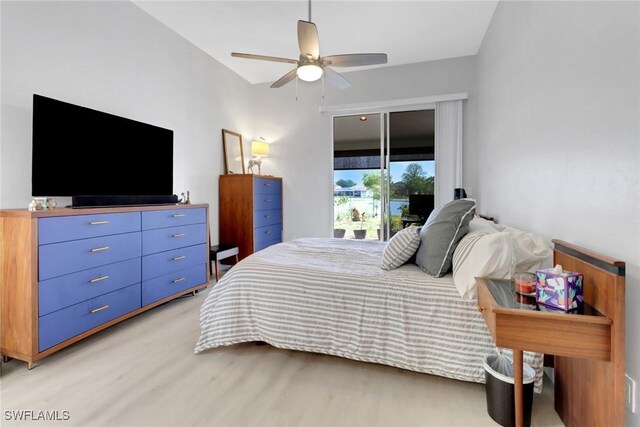 bedroom featuring access to exterior, hardwood / wood-style floors, vaulted ceiling, and ceiling fan