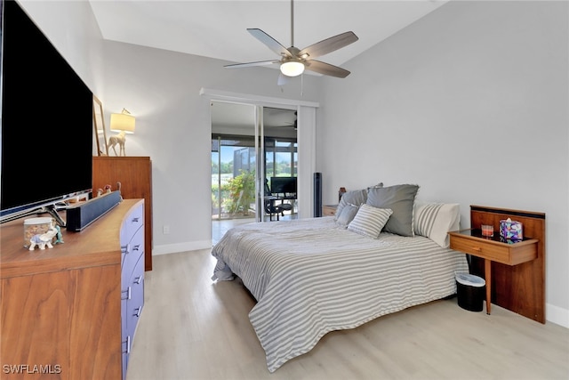 bedroom featuring access to outside, ceiling fan, light hardwood / wood-style floors, and vaulted ceiling