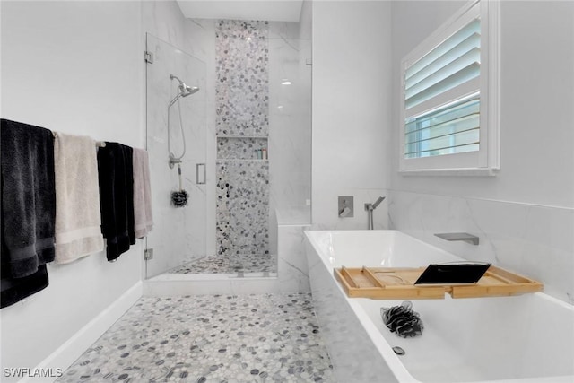 bathroom featuring shower with separate bathtub