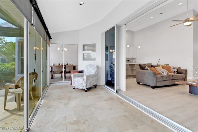 sunroom / solarium featuring ceiling fan and lofted ceiling