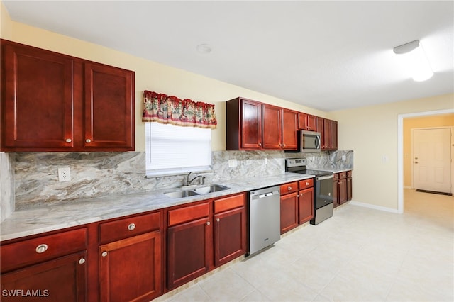 kitchen with tasteful backsplash, light stone counters, sink, and stainless steel appliances