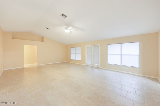 spare room featuring ceiling fan, light tile patterned flooring, and vaulted ceiling