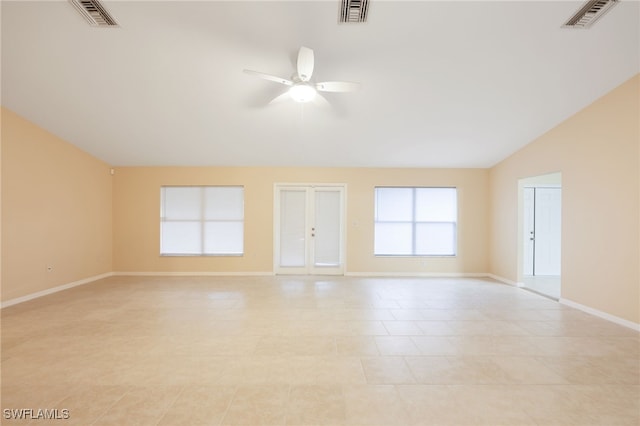 unfurnished room featuring vaulted ceiling, ceiling fan, and light tile patterned flooring