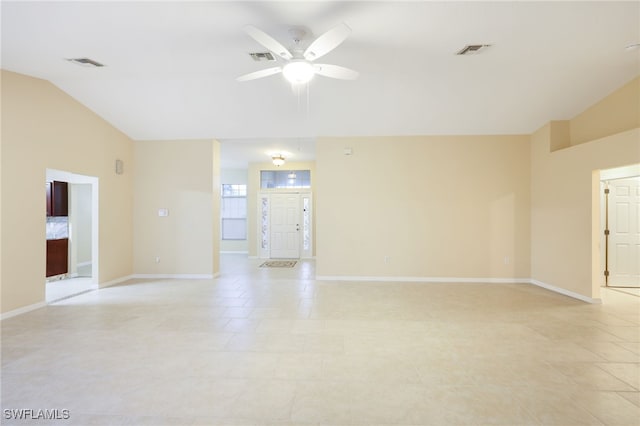 empty room with ceiling fan and vaulted ceiling