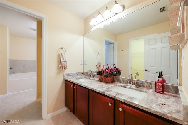 bathroom with vanity, a tub to relax in, and tile patterned floors