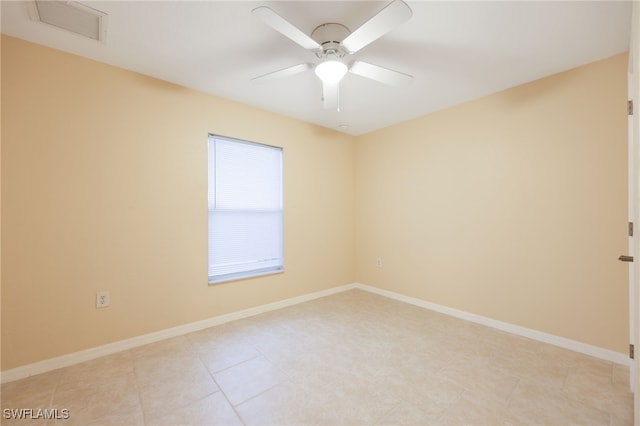 tiled empty room featuring ceiling fan