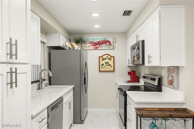 kitchen with white cabinets, appliances with stainless steel finishes, and sink