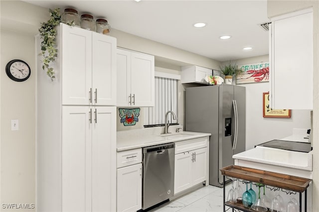 kitchen featuring white cabinets, sink, and stainless steel appliances