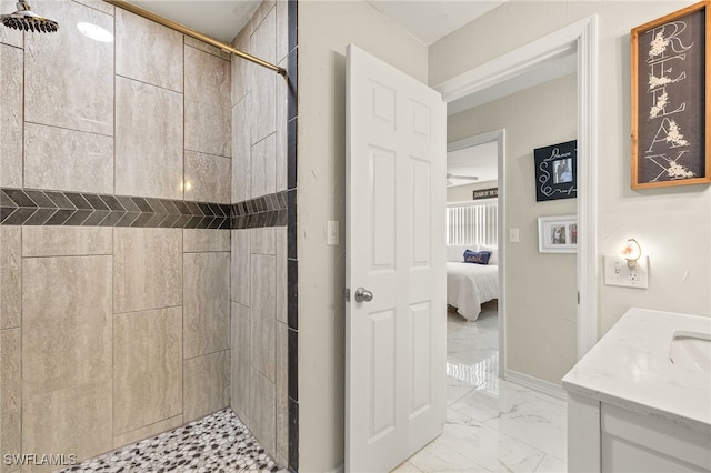 bathroom with vanity and tiled shower