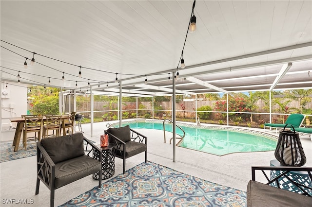 view of swimming pool featuring a patio area and a lanai