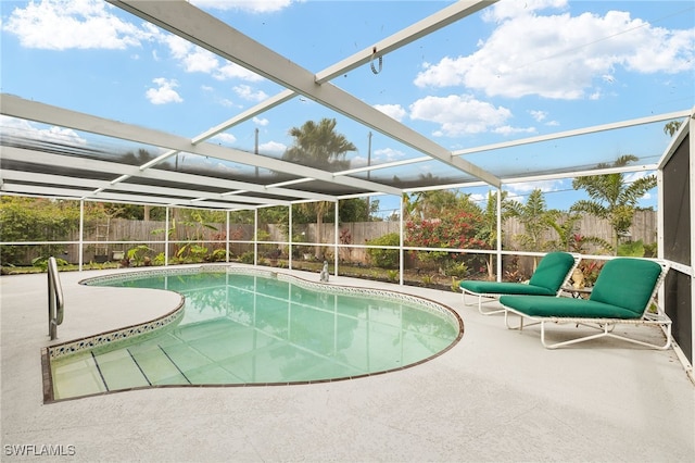 view of swimming pool featuring a patio area and a lanai