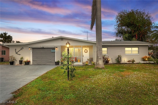 ranch-style house featuring a garage, central air condition unit, and a lawn