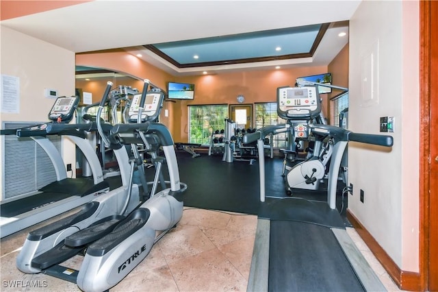 exercise room with a tray ceiling