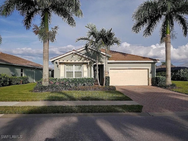 view of front of home featuring a garage and a front lawn