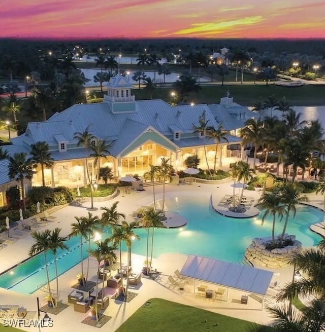 pool at dusk with a patio