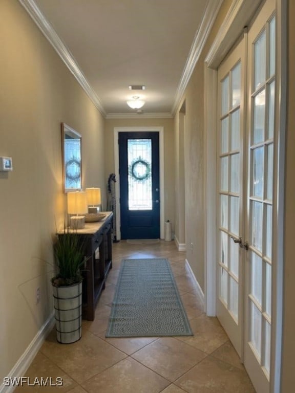 doorway with french doors, light tile patterned floors, and ornamental molding