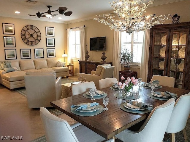 tiled dining space with ceiling fan with notable chandelier and ornamental molding