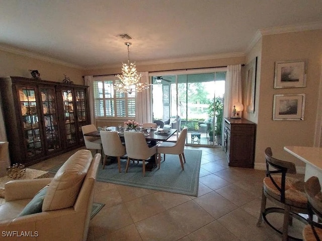 dining space featuring a chandelier, light tile patterned floors, and ornamental molding