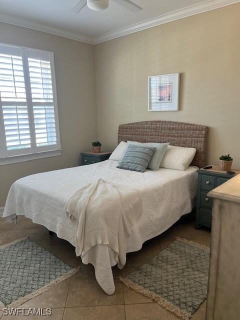 tiled bedroom featuring ceiling fan and ornamental molding