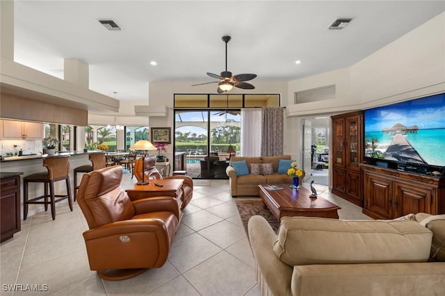 living room featuring ceiling fan and light tile patterned floors