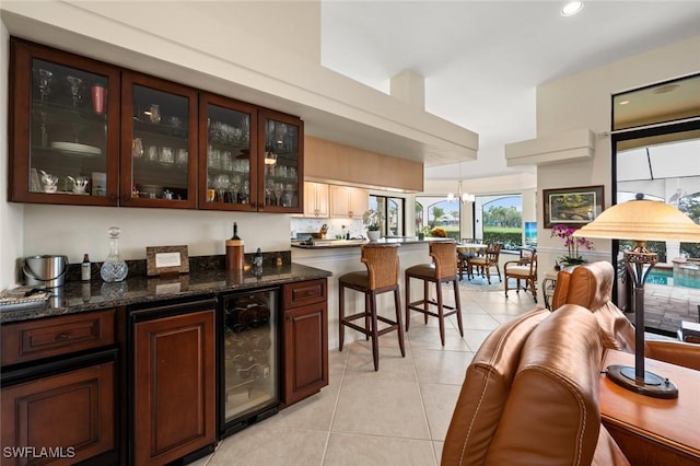 20273 Leopard Ln, Estero, FL 33928 - bar area featuring beverage cooler, light tile patterned floors, recessed lighting, and hanging light fixtures
