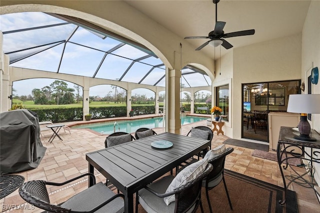 view of patio featuring ceiling fan, a lanai, exterior bar, and area for grilling