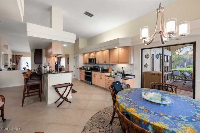 dining room with a notable chandelier and light tile patterned flooring