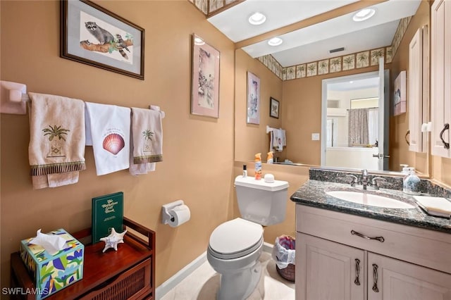 bathroom featuring toilet and vanity